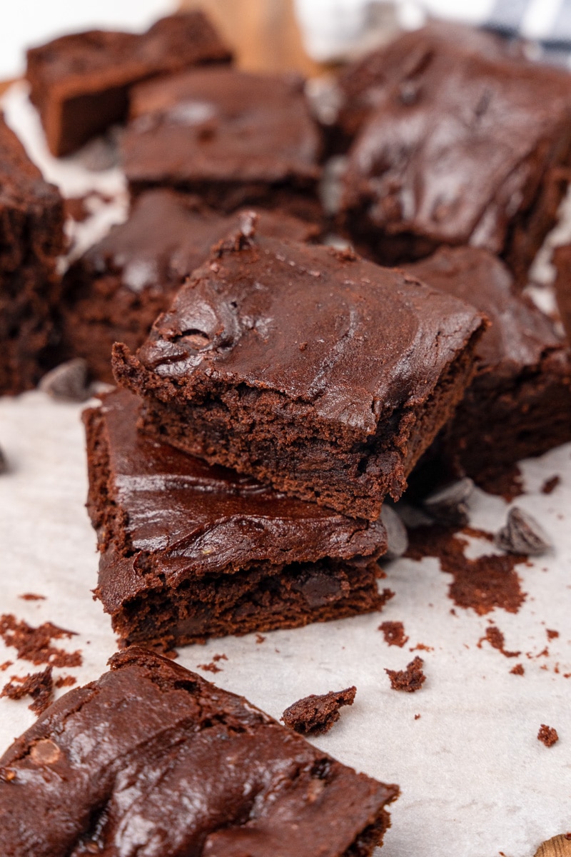 avocado brownies stacked on parchment paper