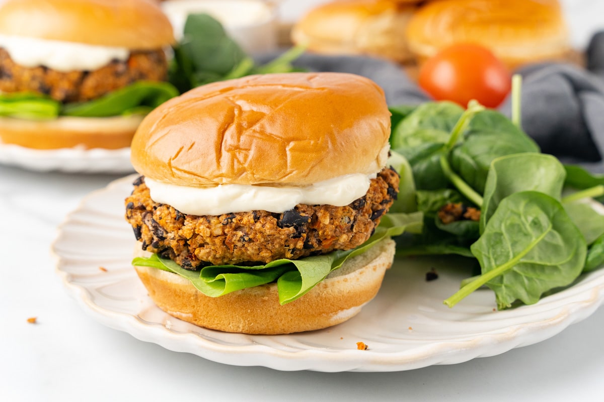 vegan chipotle black bean burger being served on a bun