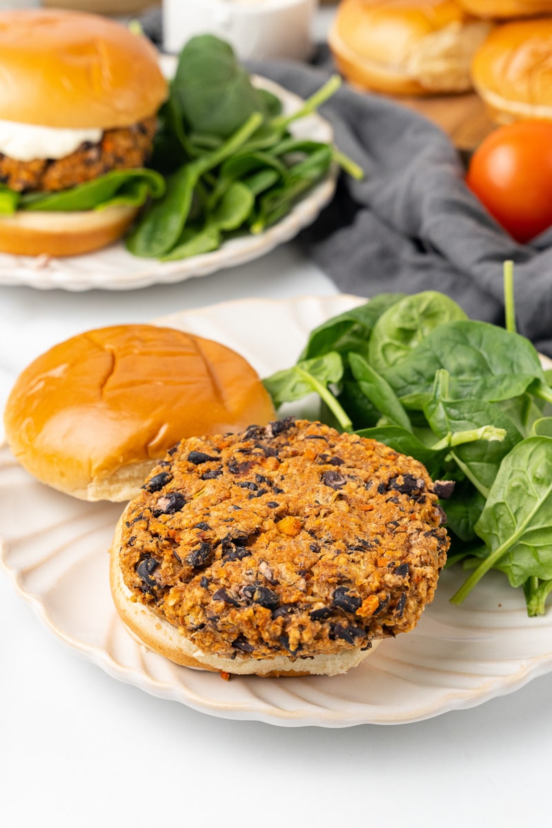 chipotle black bean burger on a bun being served