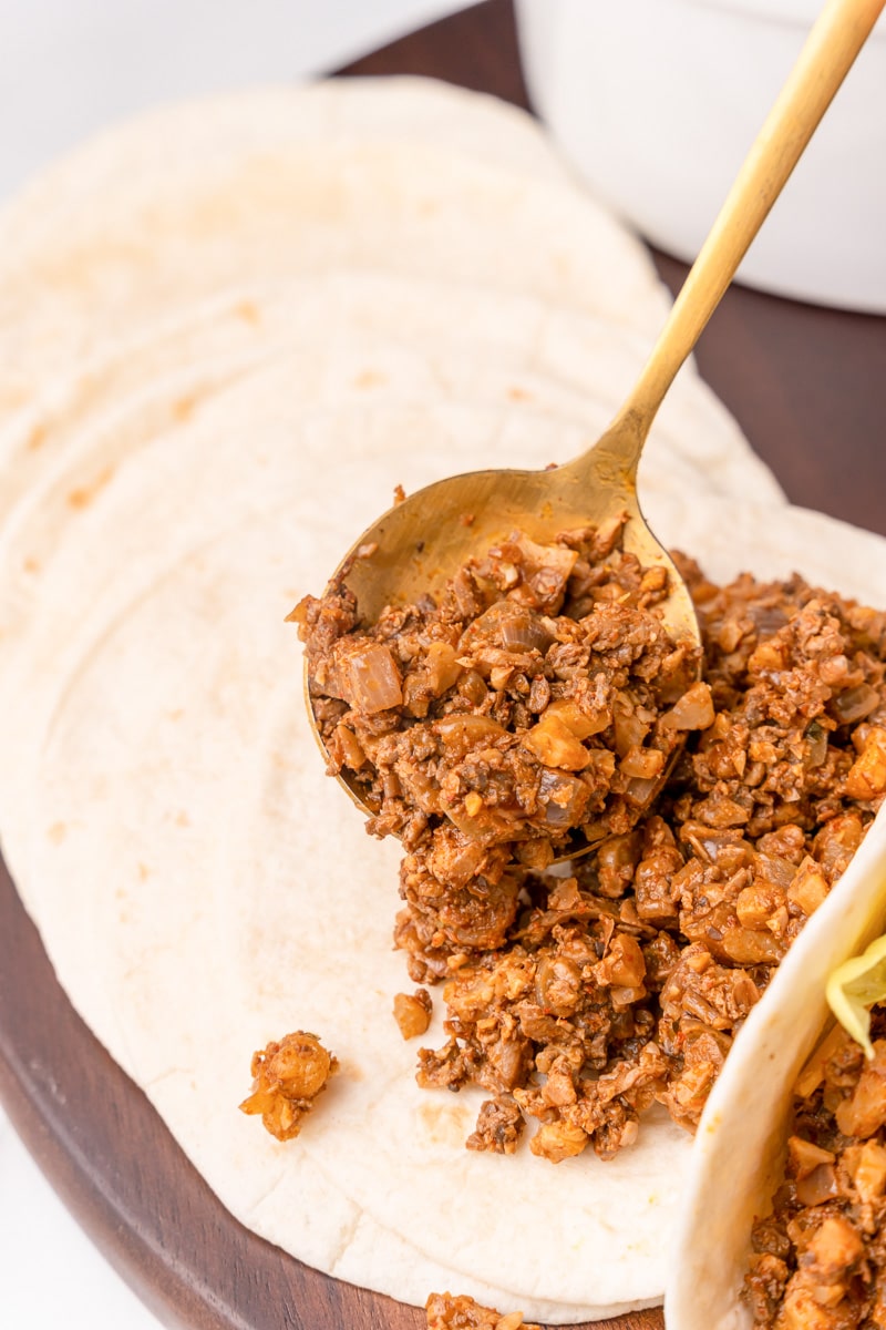 serving the vegan walnut taco meat over tortillas