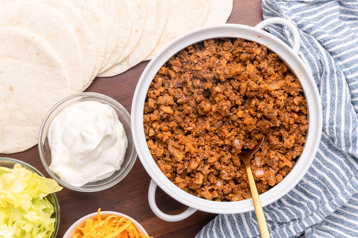 vegan walnut taco meat being served with tortillas and taco toppings