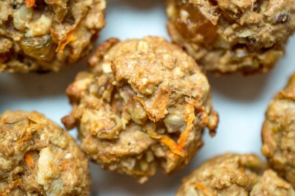 close up of vegan carrot muffins with carrots, raisins, and walnuts
