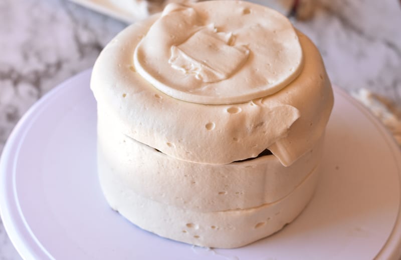 vegan cream cheese frosting being iced onto cake