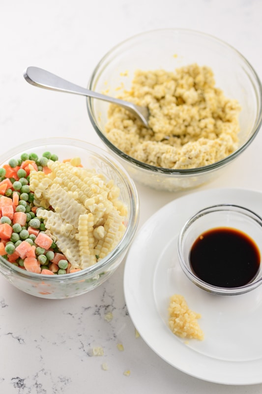 veggies and tofu in bowls for making vegan fried rice