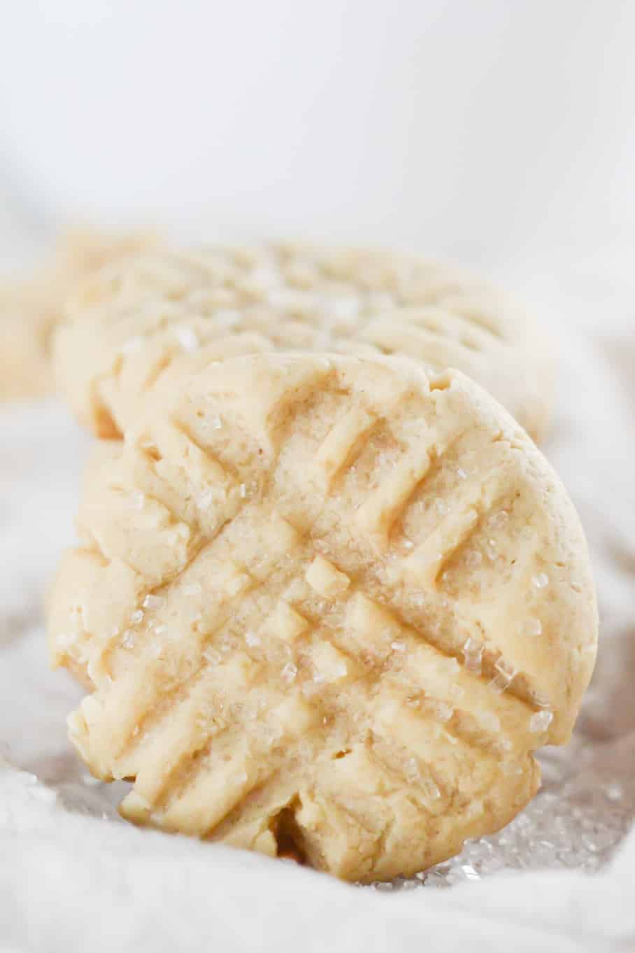 close up view of vegan sugar cookies on white background with coarse sugar