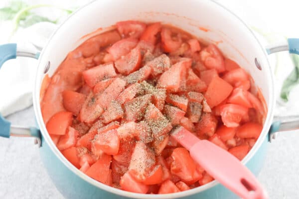 tomatoes being cooked on the stove top for tomato soup