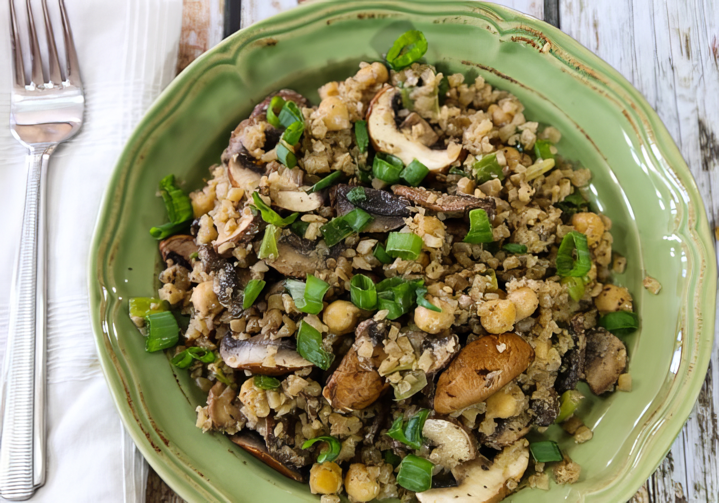 Cauliflower fried rice with mushrooms and chickpeas in a skillet