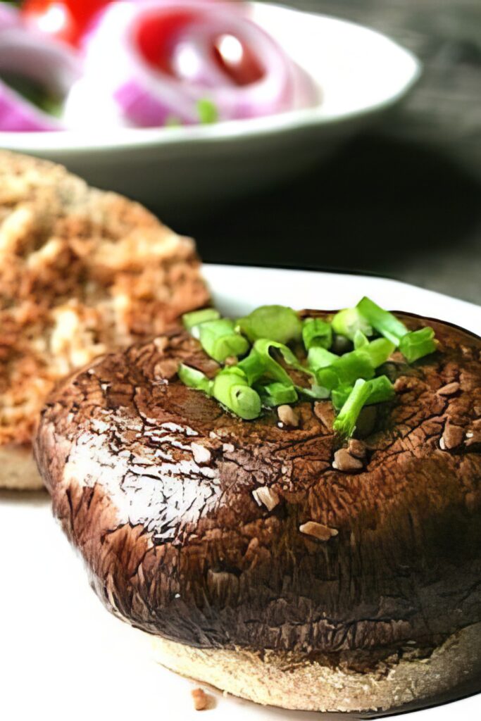Vegan portobella burger stacked on a serving board
