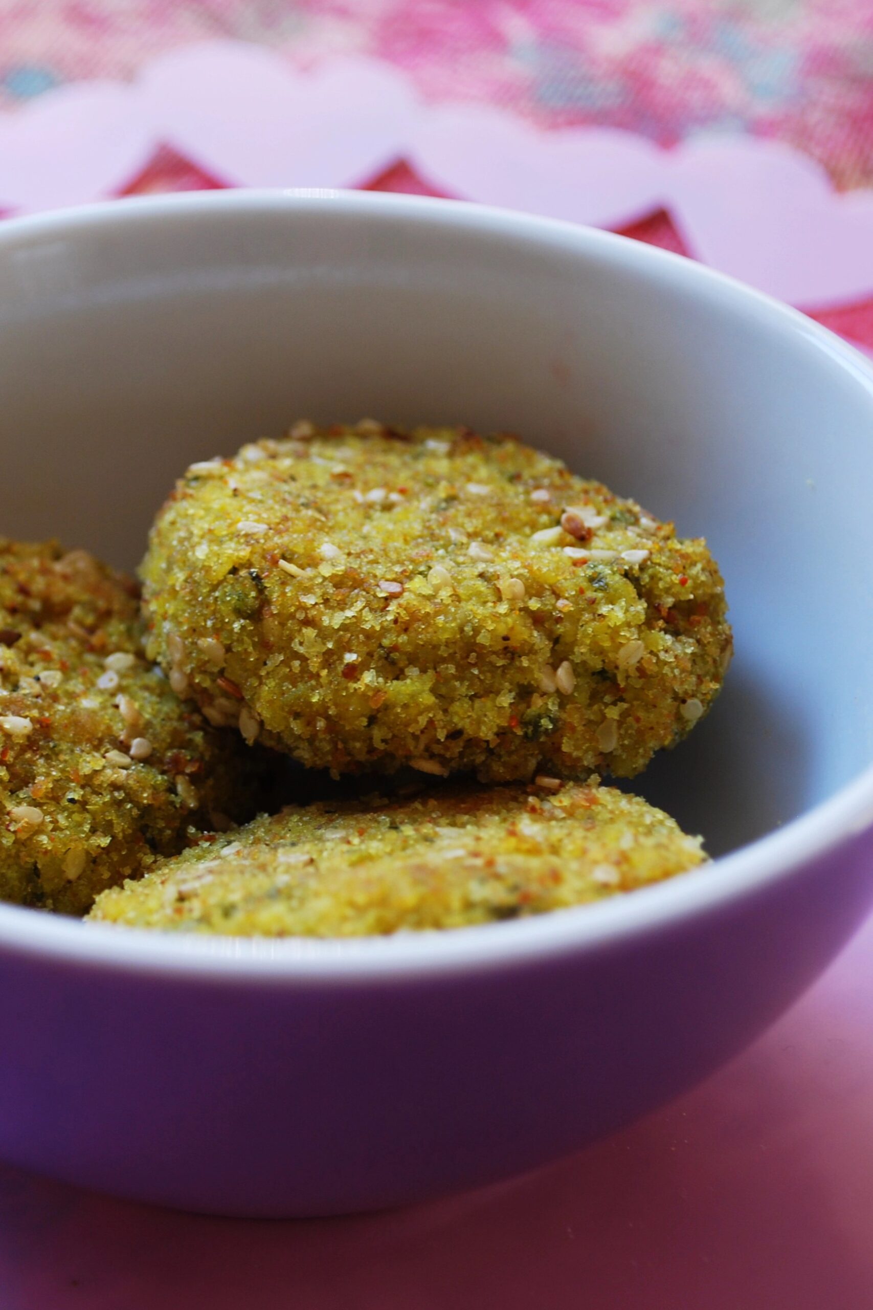 Vegan curried tofu burger patties stacked on a board