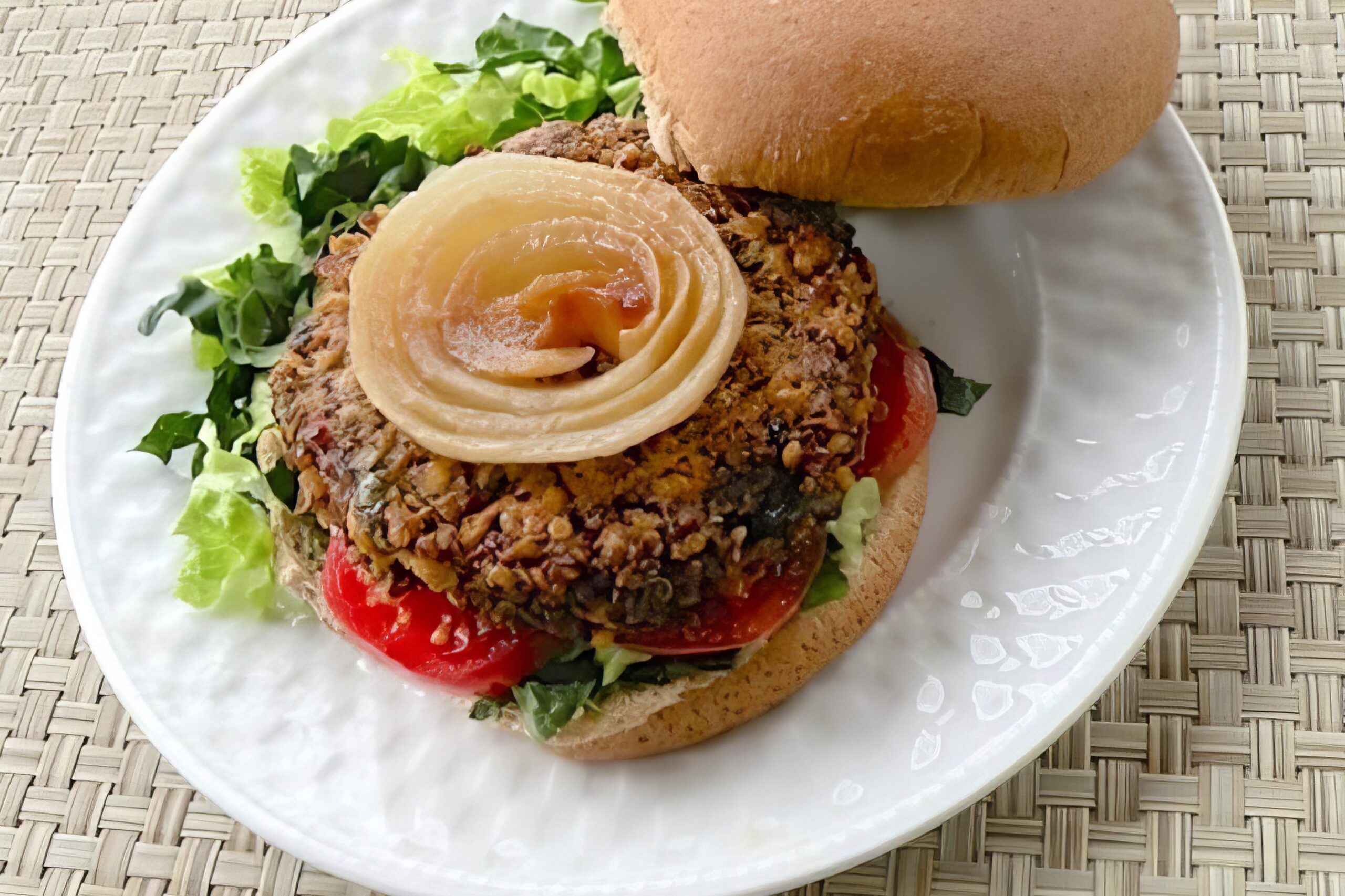 Vegan quinoa mushroom burger on a whole grain bun