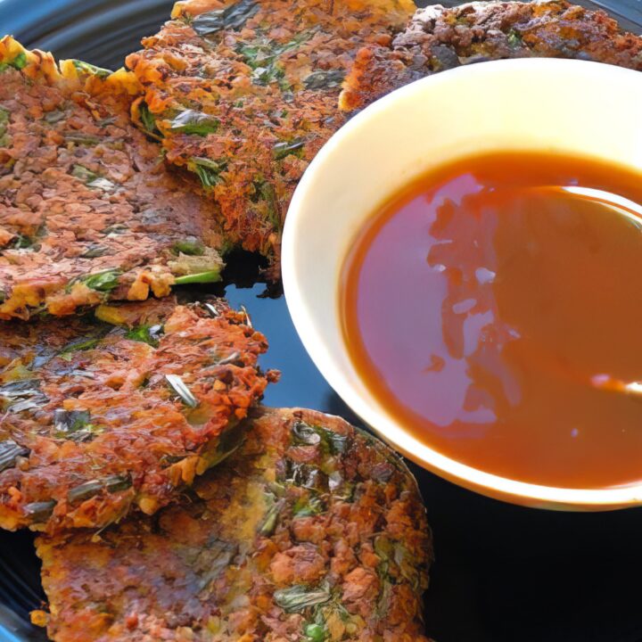 Homemade vegan duck sauce in a small bowl with a spoon
