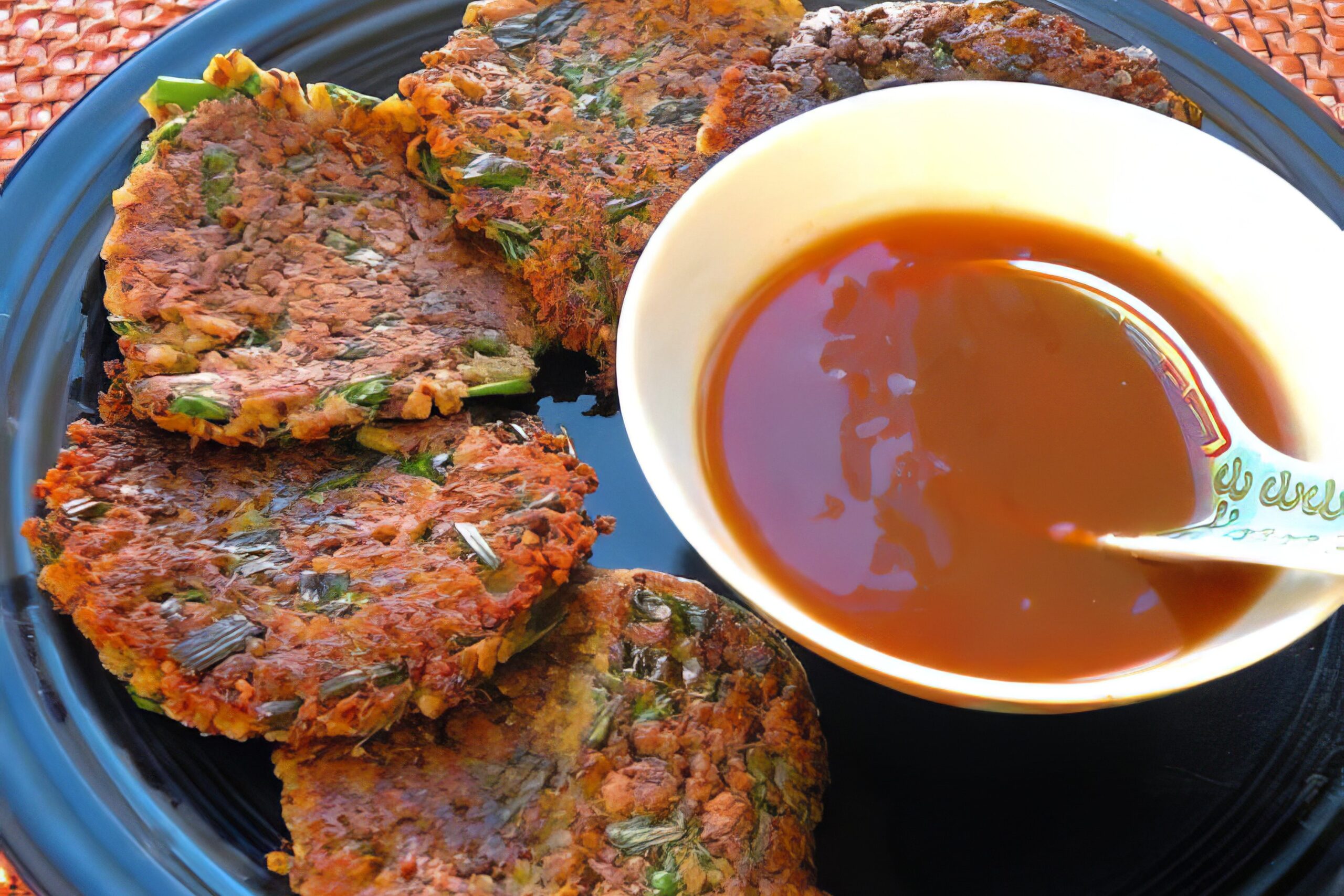 Homemade vegan duck sauce in a small bowl with a spoon