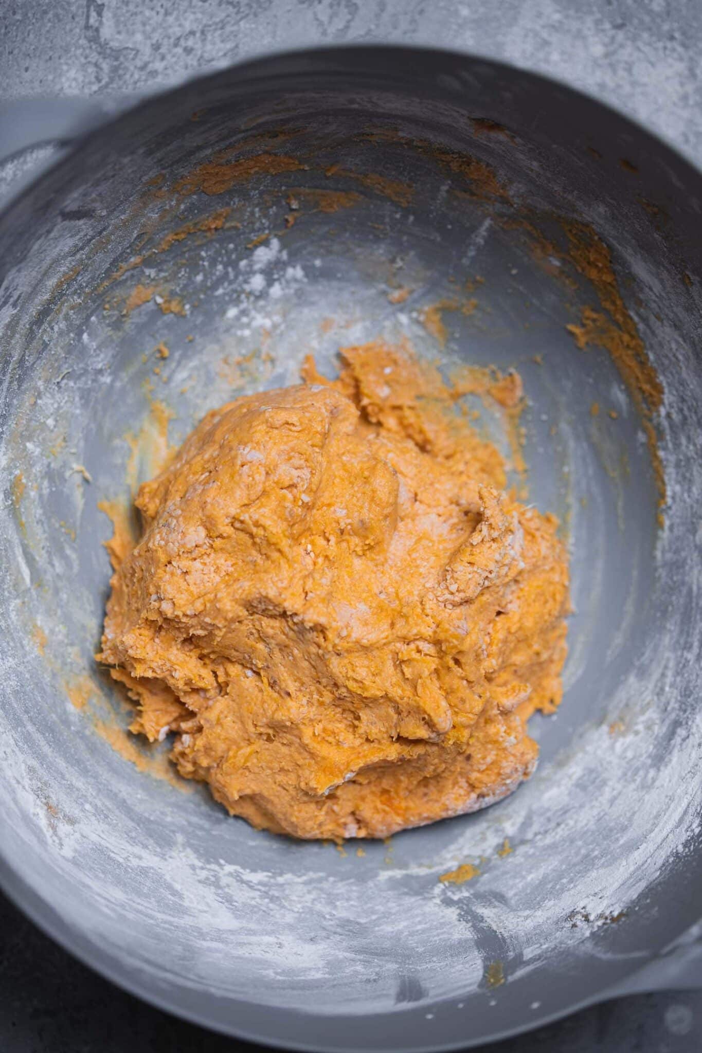Sweet potato gnocchi dough mixed in a grey bowl