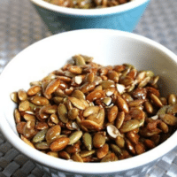 Candied pumpkin seeds in a white bowl