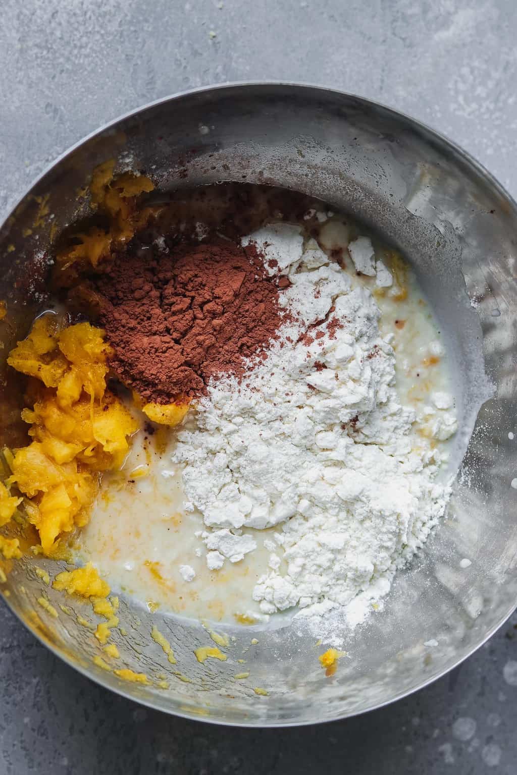 Mixing bowl with pumpkin puree, cacao powder, gluten-free flour and plant milk for pancake batter