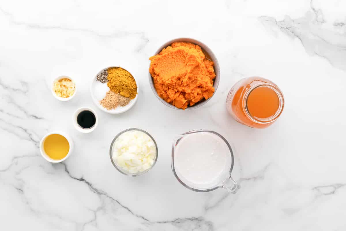Ingredients for curry pumpkin soup: pumpkin puree, coconut milk, broth, onion, garlic and spices
