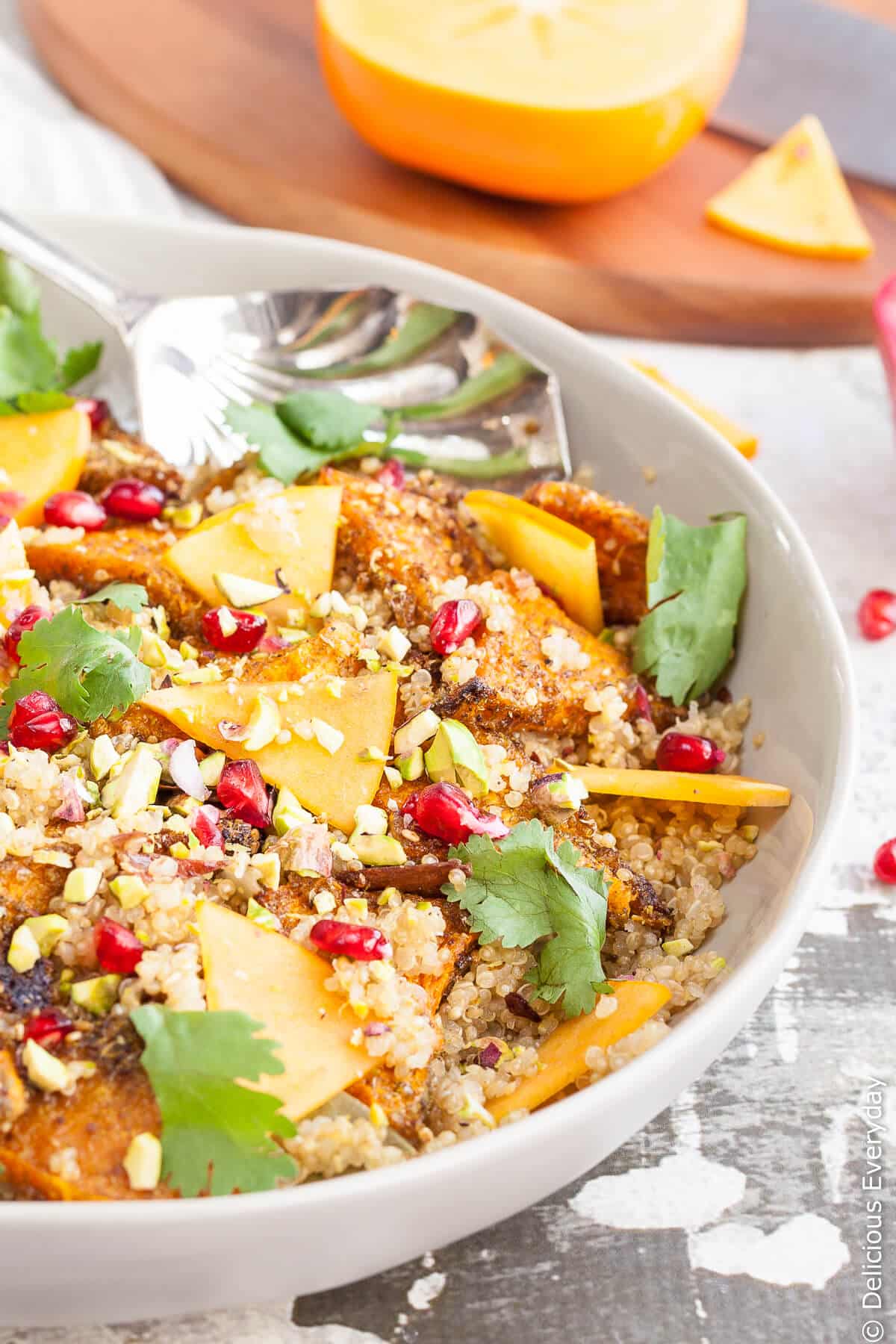 Pumpkin quinoa pilaf with pomegranate and pistachios served with a spoon
