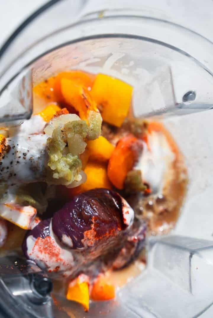 Roasted pumpkin, carrots and onion with coconut milk in a blender
