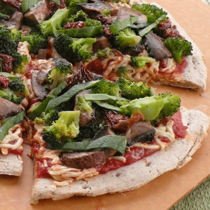 Vegan broccoli, mushroom, and sun-dried tomato pizza