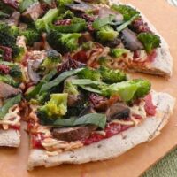 Vegan broccoli, mushroom, and sun-dried tomato pizza