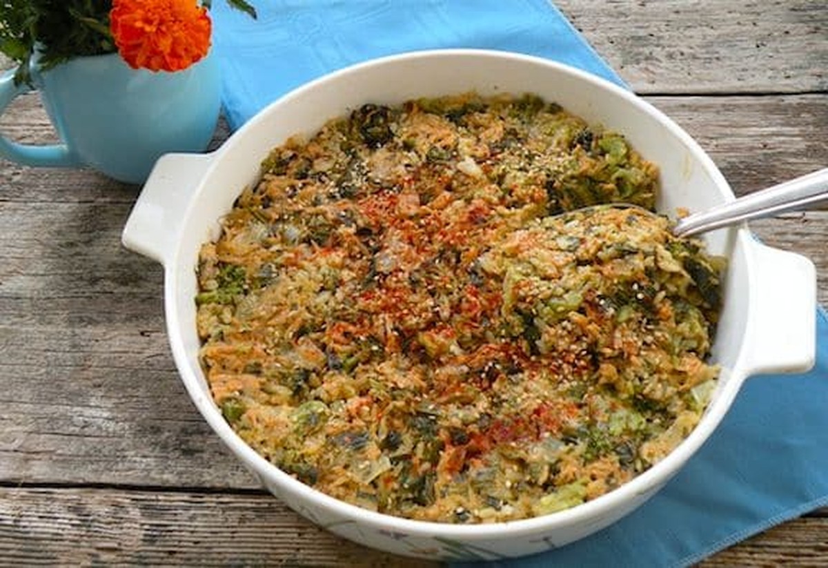 Vegan cheddar and broccoli rice casserole in a white baking dish