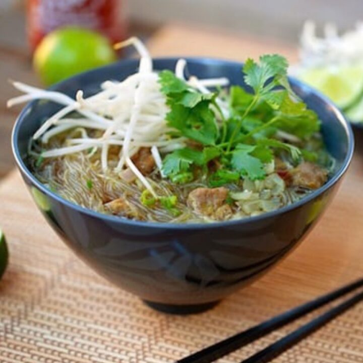 Bowl of vegan pho bo with seitan, rice noodles, bean sprouts, and cilantro