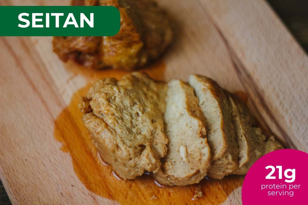 Sliced seitan on a wooden board, labeled 21 g protein per serving