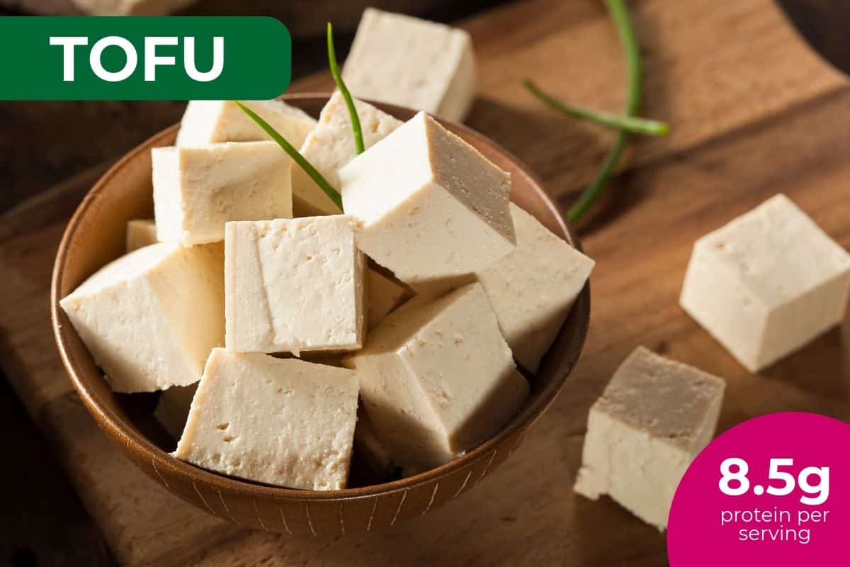 Cubes of extra-firm tofu in a wooden bowl, labeled 8.5 g protein per serving