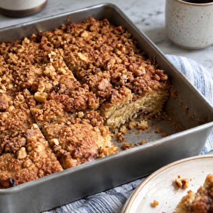 Vegan coffee cake with cinnamon-walnut crumble cut into squares in a 9x9 baking pan